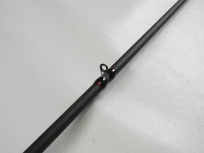 A close-up of a Falcon EVO VFC-7-173 7'3" Heavy Casting Rod in excellent condition is shown against a white background. This black rod, with red-accented eyelets, qualifies for our Rod and Reel Trade-In Program.