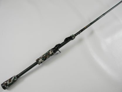 The Phenix Maxim PHX-MAX-C610MH 6'10" Medium Heavy casting rod, featuring a camouflage-patterned handle and reel seat with a textured grip for enhanced handling, is perfect for our Rod and Reel Trade-In Program—trade your used gear and earn store credit!.
