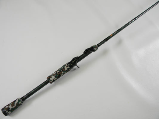 The Phenix Maxim PHX-MAX-C610MH 6'10" Medium Heavy casting rod, featuring a camouflage-patterned handle and reel seat with a textured grip for enhanced handling, is perfect for our Rod and Reel Trade-In Program—trade your used gear and earn store credit!.
