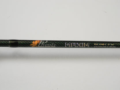 Close-up of a Phenix Maxim PHX-MAX-C610MH 6'10" Medium Heavy Fishing Rod, highlighting carbon fiber texture and detailed specs. Consider trading your used gear through our Rod and Reel Trade-In Program for store credit. Background is plain white.