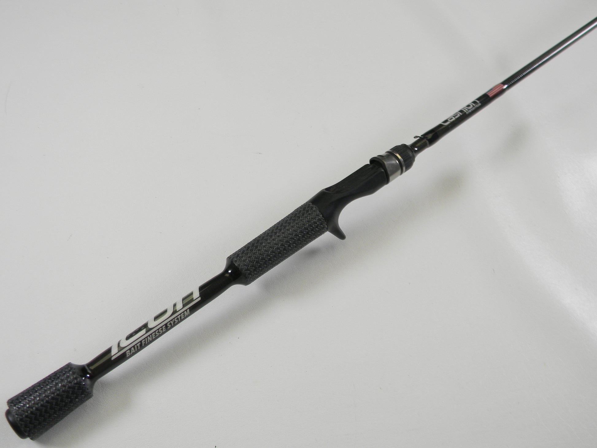 A black and silver Cashion Icon Series iBFS610MLF 6'10" medium light casting rod with a textured grip and sleek, lightweight design is shown diagonally against a white background. Perfect for the Rod and Reel Trade-In Program or earning store credit through our used gear condition process.