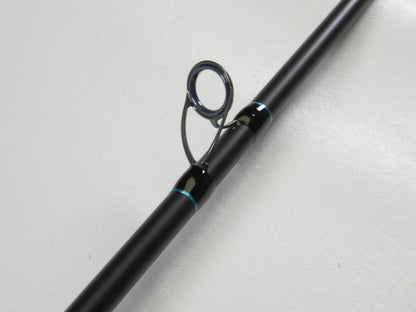 Close-up of a G. Loomis IMX-PRO Blue 845C M 7'0" Heavy Used Casting Rod in excellent condition, featuring a black finish and guide with metallic ring—ideal for those trading in gear for store credit.