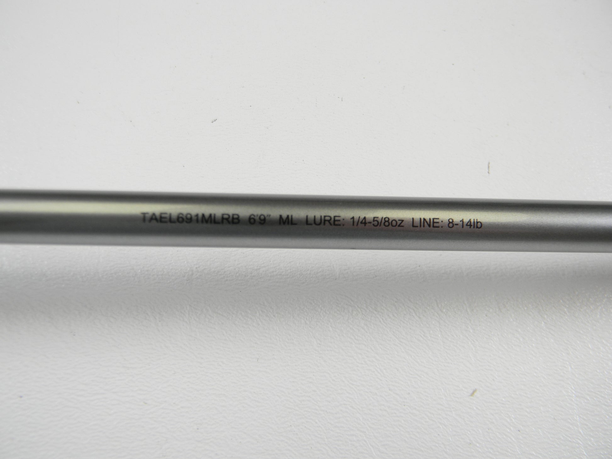A close-up of the Daiwa Tatula Elite TAEL691MLRB 6'9" ML Used Casting Rod in mint condition, showing “LURE: 1/4–5/8oz LINE: 8–14lb” on its shaft—great for a Rod and Reel Trade-In or adding quality used gear.