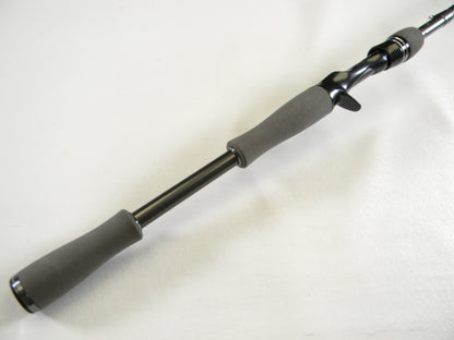 Close-up of the Daiwa Tatula Elite TTEL731HFB casting rod handle on a white background. The sleek, black design includes gray ergonomic grips and a trigger grip seat for comfort. Trade in your old gear via our Rod and Reel Trade-In Program to get store credit for an upgrade.
