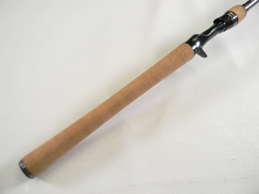 Close-up of the Daiwa Tatula Elite TTEL751HFB handle with a smooth cork grip and black reel seat. Perfect for a Rod and Reel Trade-In to refresh used gear, this mint condition 7'5" heavy casting rod stands out against the white background.