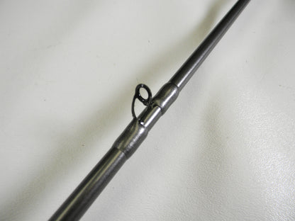 Close-up of the Daiwa Tatula Elite TTEL751HFB, a 7'5" heavy casting rod in mint condition, featuring a metal guide loop on its shaft against a white background. Ideal for upgrading through our Rod and Reel Trade-In program.