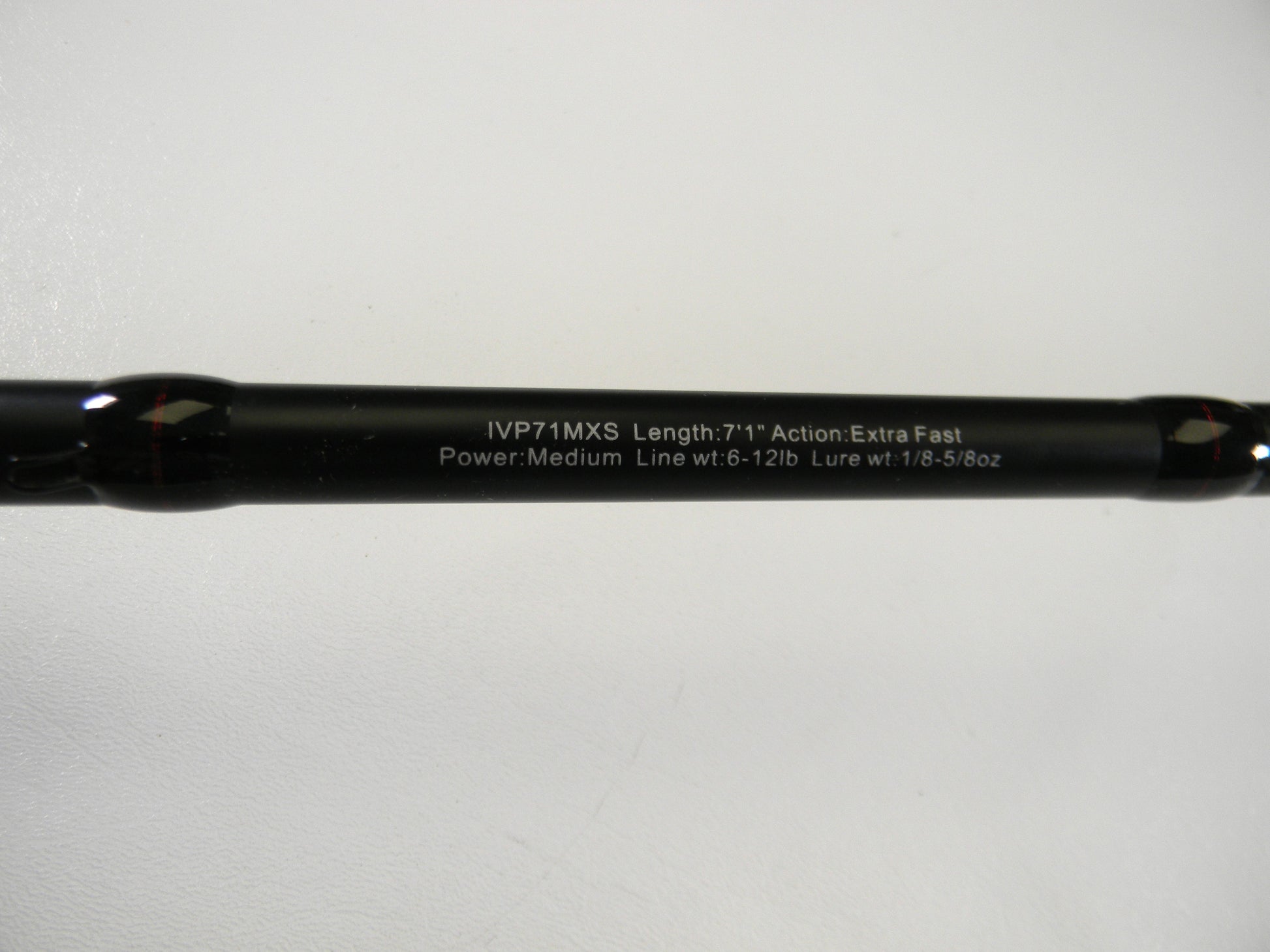 The Ark Fishing Invoker Pro IVP71MXS 7'1" Medium spinning rod in excellent used condition is featured in a close-up, highlighting its extra fast action and specifications (Line wt: 6-12lb, Lure wt: 1/8-5/8oz) against a pristine white backdrop from our Rod and Reel Trade-In Program.
