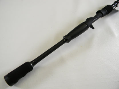 Close-up of the Abu Garcia Veritas Tournament VXTC72-5 black handle against a white background. This used casting rod features a comfortable trigger grip design. Perfect for upgrading in our Rod and Reel Trade-In program with generous store credit offers.