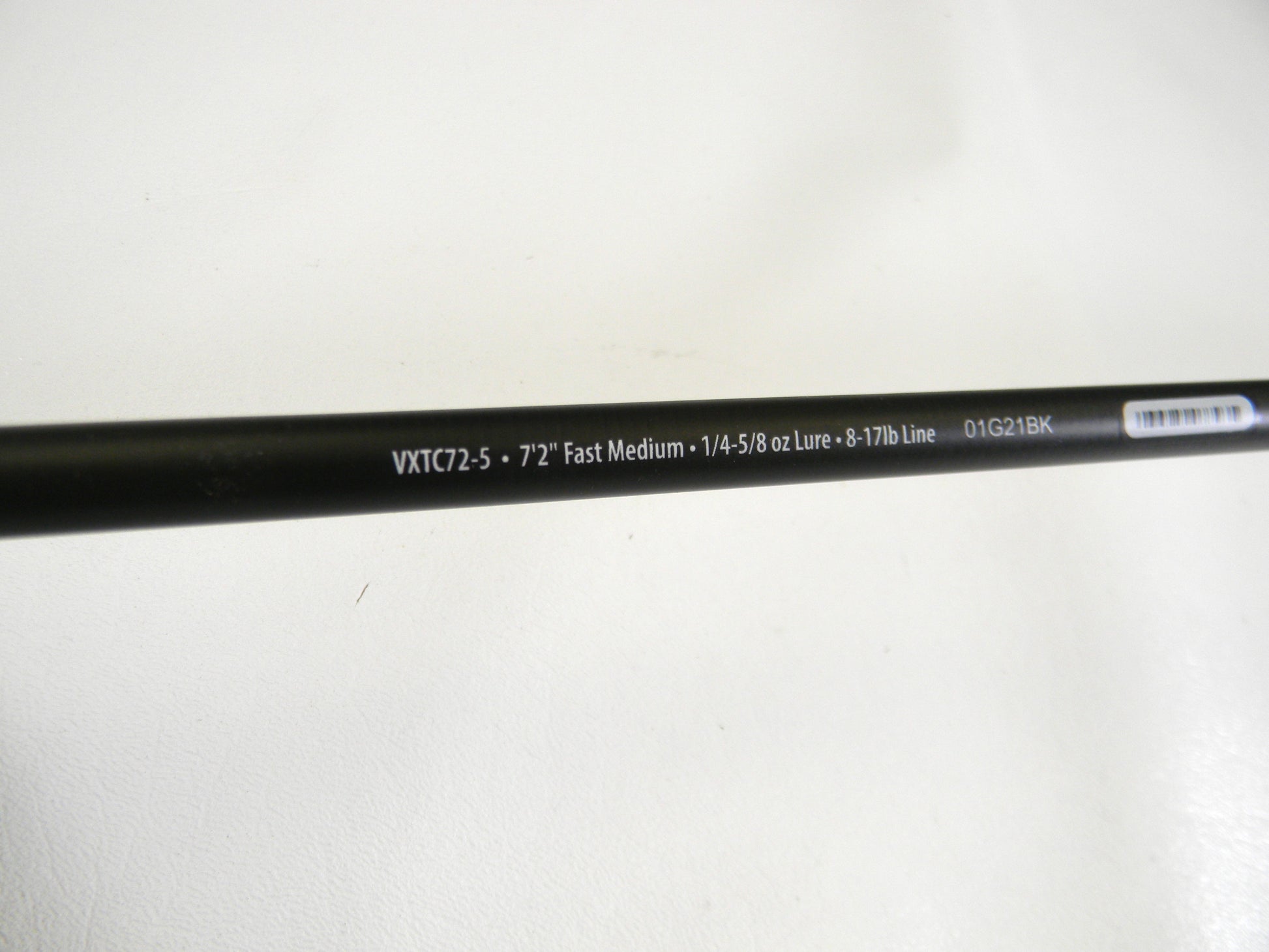 Close-up of the Abu Garcia Veritas Tournament VXTC72-5 7'2" Medium casting rod against a white background. This black rod, with white text showing specs like measurements and line weight capacity, is perfect for upgrading used gear through our Rod and Reel Trade-In program. Mint condition!.