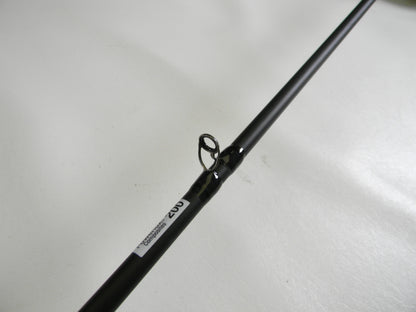A close-up of the Abu Garcia Veritas Tournament VXTC72-5 7'2" Medium casting rod, featuring a line guide labeled "202" to signify its quality. This used gear, set against a light plain backdrop, qualifies for our Rod and Reel Trade-In program.