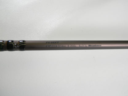 A close-up of the Megabass Orochi X10 F4-68XT Jabberwock 6'8" Medium Light Used Casting Rod (Excellent Condition), eligible for our Rod and Reel Trade-In Program, rests on a plain white surface.