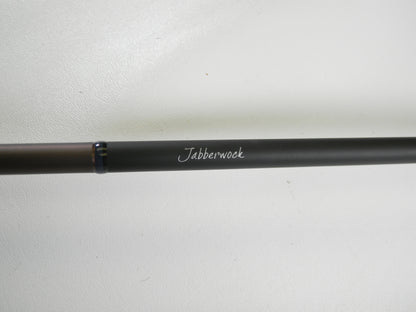 A Megabass Orochi X10 F4-68XT Jabberwock 6'8" Medium Light used casting rod in excellent condition, black with "Jabberwock" in white script, shown on a plain white background—eligible for our Rod and Reel Trade-In Program.
