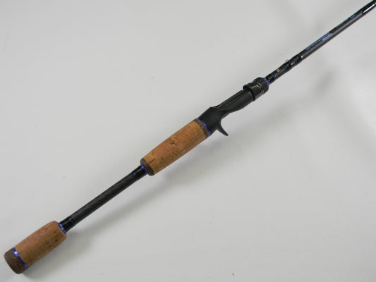 The Dobyns Champion XP DC703C 7'0" Medium Heavy Used Casting Rod, shown diagonally on a white background, is in excellent condition—ideal for anglers considering our rod and reel trade-in program for store credit.