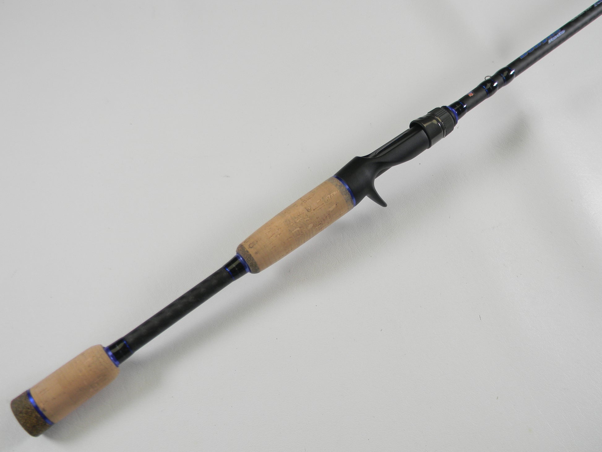 A Dobyns Champion XP DC705C 7'0" Mag Heavy Casting Rod with cork handle and black reel seat is shown on a white background—ideal for upgrading via our Rod and Reel Trade-In Program.