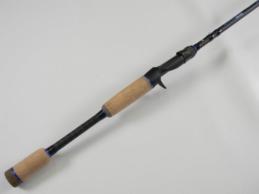 A Dobyns Champion XP DC705C 7'0" Mag Heavy Casting Rod with cork handle and black reel seat is shown on a white background—ideal for upgrading via our Rod and Reel Trade-In Program.