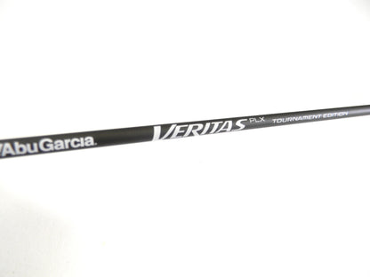 A close-up shows an Abu Garcia Veritas Tournament VXTS610-4 in mint condition with "Veritas PLX Tournament Edition" in white on a black background and "Abu Garcia" at the bottom left, set against a plain, light-colored backdrop. Ideal for this Rod and Reel Trade-In opportunity.