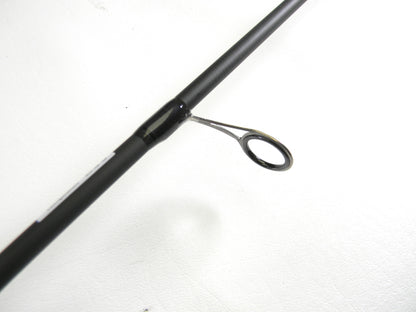 A close-up of an Abu Garcia Veritas Tournament VXTS610-4 6'10" Medium Light spinning rod guide against a white background is available through our Rod and Reel Trade-In program. The rod's black finish contrasts strikingly with the silver circular guide ring.