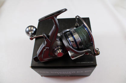 A Daiwa Free Swimmer EX BR 10000 used spinning reel in excellent condition, with a green fishing line spool, is mounted on a black box labeled "FREE SWIMMER EX BR 10000" against a plain white background—ideal for trade-in.
