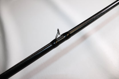 A close-up of the 13 Fishing Envy Black EB3C79C Crank casting rod, in good used condition, shows a single metal guide eyelet against a plain white background.