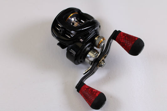 The Lew's Tournament MB LFS TS1SHMBL 7.5:1 LH Used Casting Reel in Good Condition, with metallic accents and red handles, is the perfect choice to trade in through our Rod and Reel Trade-In Program for store credit.