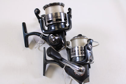 Two used Abu Garcia spinning reels (Orra Power Finesse 35 & Cardinal STX20) in good condition, silver and black with line—great for your next rod and reel trade-in or to upgrade your fishing gear collection.