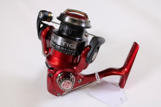 A close-up of a Quantum Kinetic PT10 used spinning reel in excellent condition, shown on a white surface—ideal for those exploring our Rod and Reel Trade-In Program or seeking quality pre-owned gear.