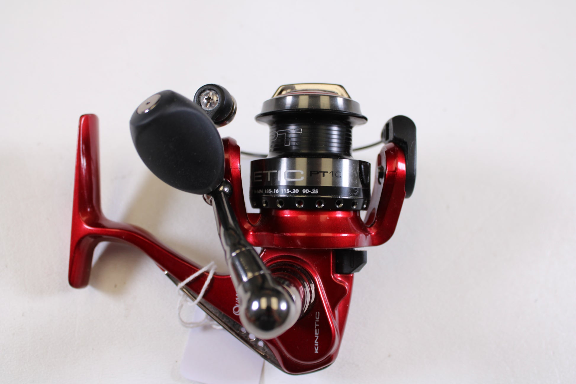A red and black Quantum Kinetic PT10 used spinning reel in excellent condition is ideal for anglers seeking quality gear or those interested in a Rod and Reel Trade-In Program for store credit.