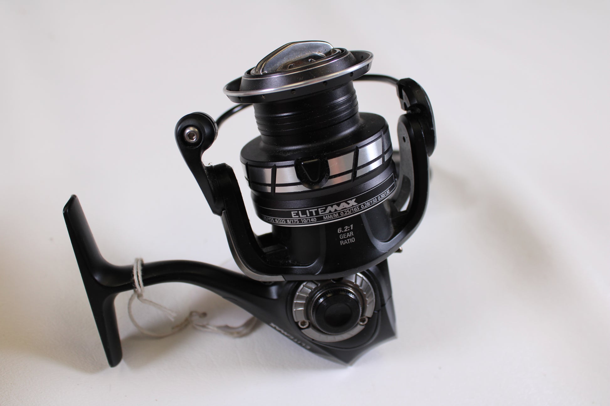 An Abu Garcia Elite Max 30 6.2:1 Used Spinning Reel in excellent condition is shown with a white string on the handle—perfect for the Rod and Reel Trade-In Program or upgrading your used gear collection.