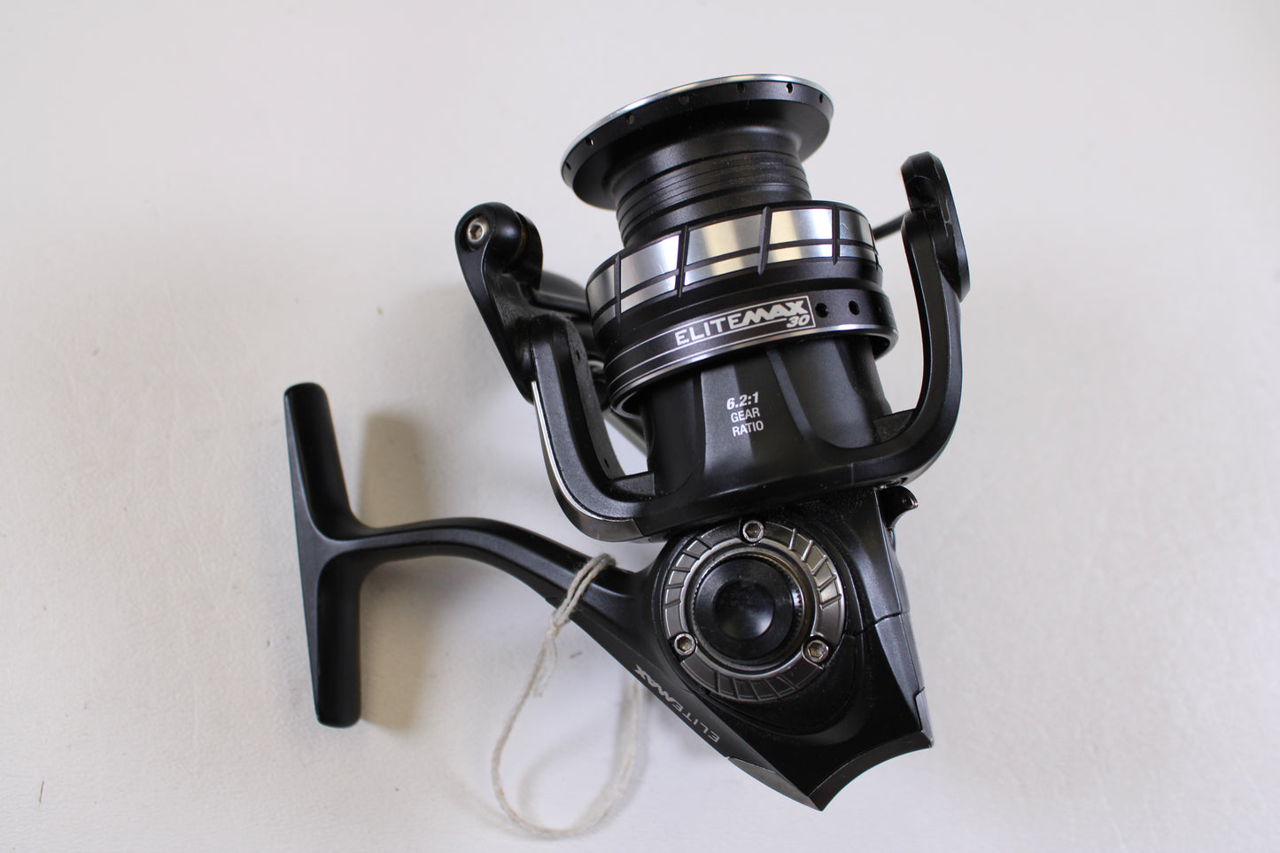 An Abu Garcia Elite Max 30 6.2:1 used spinning reel in excellent condition with silver accents is displayed on a white surface—perfect for trading in your old gear through our Rod and Reel Trade-In Program.