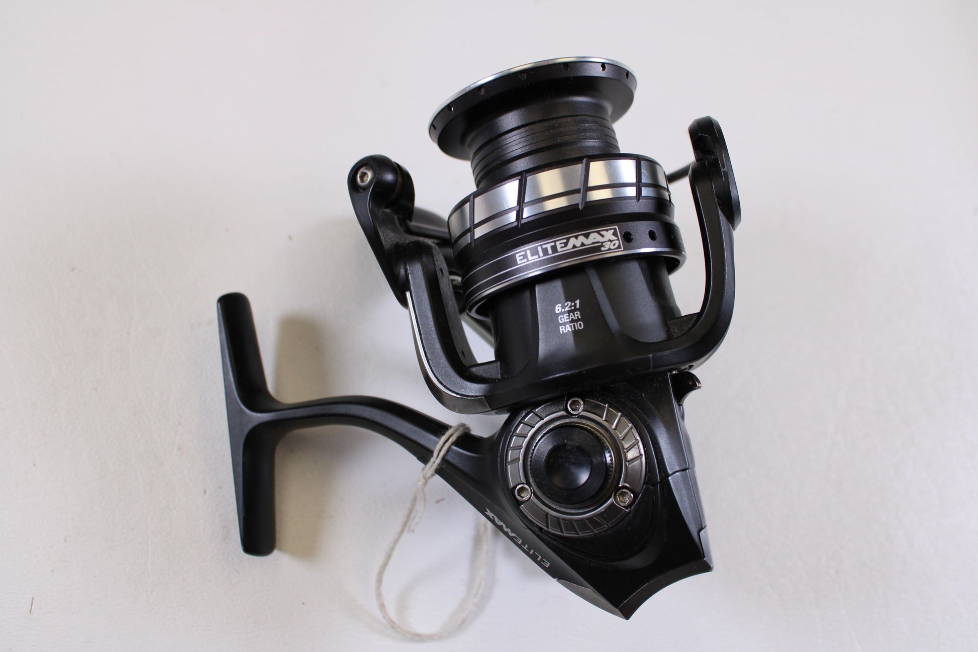 An Abu Garcia Elite Max 30 6.2:1 used spinning reel in excellent condition with silver accents is displayed on a white surface—perfect for trading in your old gear through our Rod and Reel Trade-In Program.