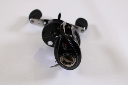 An Abu Garcia Revo Winch Gen 2 5.4:1 RH used casting reel in excellent condition is shown on a white surface from a slightly elevated angle—ideal for those seeking savings through our Rod and Reel Trade-In Program.