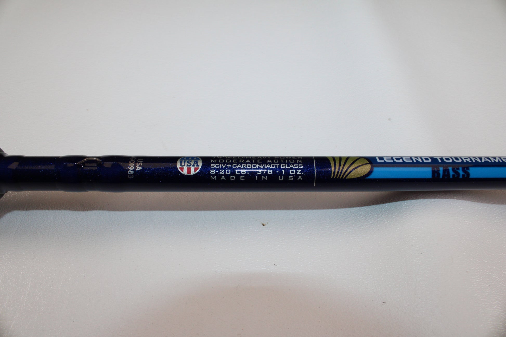 A close-up of a St. Croix Legend Tournament Bass LBTC74MHM Power Glass Cranker 7'4" Medium Heavy Used Casting Rod in excellent condition, featuring moderate action, SCLV carbon/glass, 8–20 lb line, and 3/8–1 oz. lure specs.