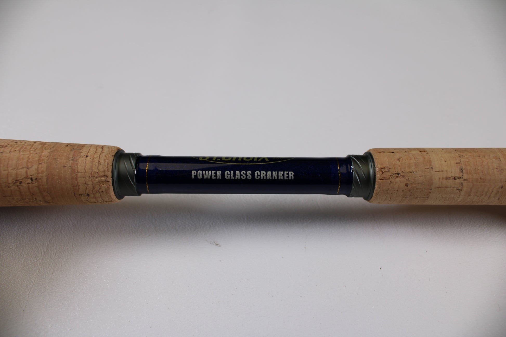 A close-up of the St. Croix Legend Tournament Bass LBTC74MHM Power Glass Cranker 7'4" Medium Heavy used casting rod with cork grips—eligible for our Rod and Reel Trade-In Program for store credit on excellent condition gear.