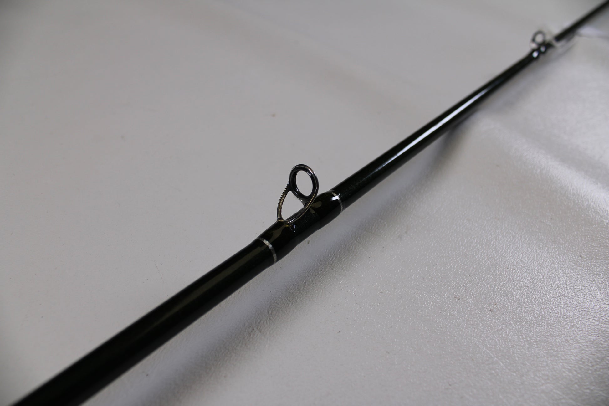 A close-up of a St. Croix Legend Elite EC70MF 7'0" Medium used casting rod in excellent condition, highlighting a line guide—ideal for those interested in quality used gear or our Rod and Reel Trade-In Program.