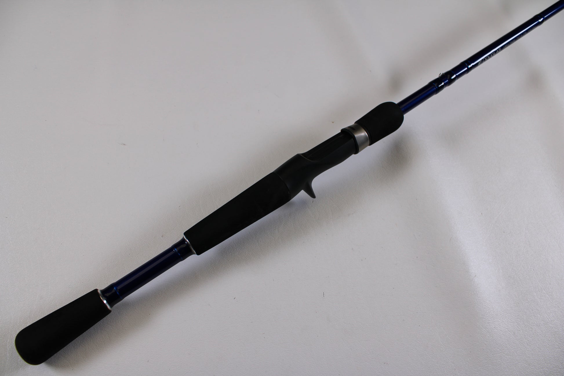 A close-up of the Douglas LRS C704M 7'0" Medium Used Casting Rod—excellent condition, shown diagonally on a white surface. Ideal for upgrading via our Rod and Reel Trade-In Program or shopping for top-quality used Douglas gear.