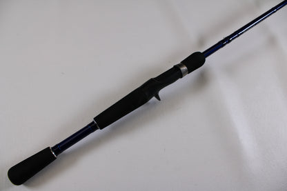 A close-up of the Douglas LRS C704M 7'0" Medium Used Casting Rod—excellent condition, shown diagonally on a white surface. Ideal for upgrading via our Rod and Reel Trade-In Program or shopping for top-quality used Douglas gear.