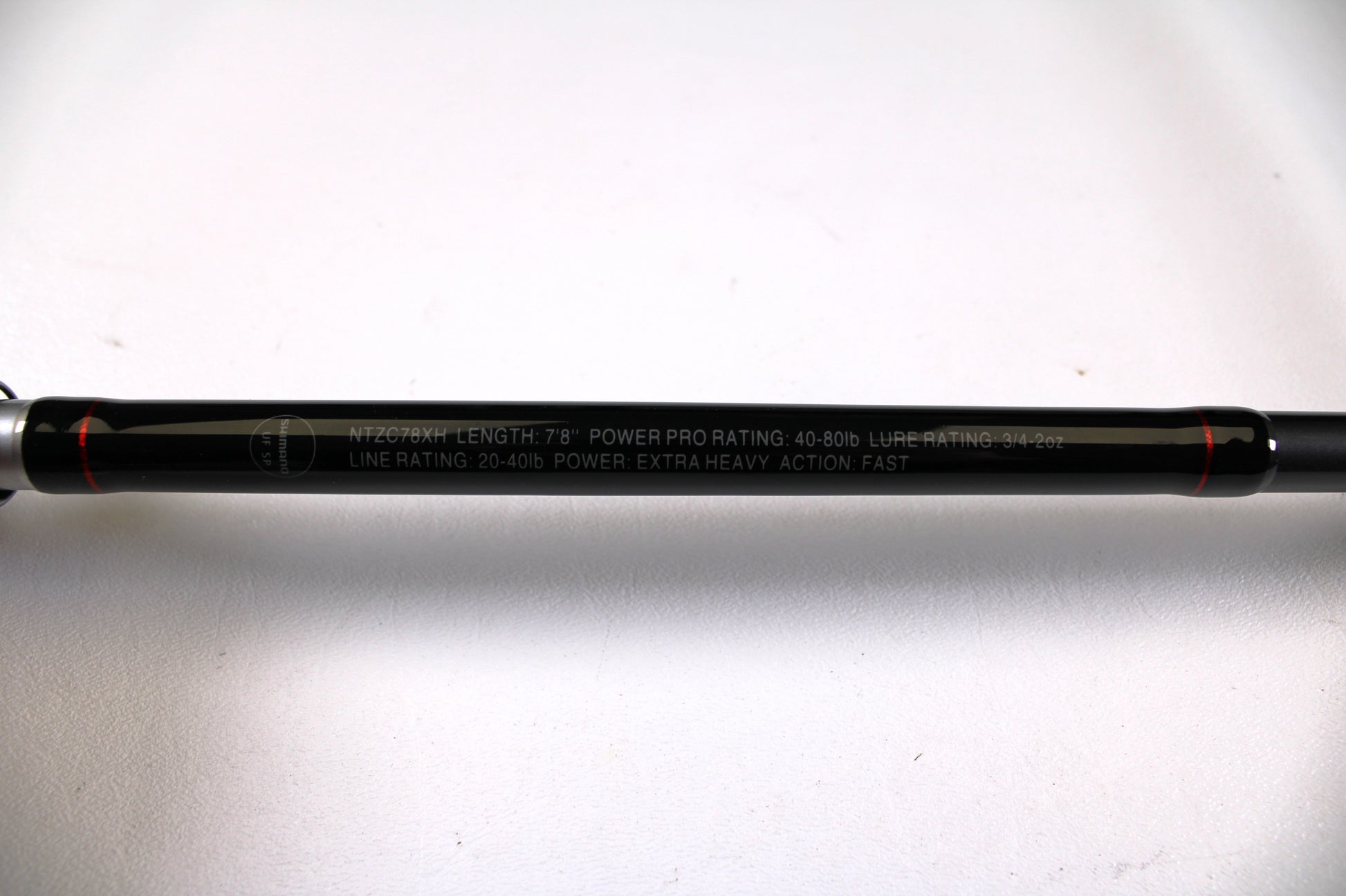 Close-up of a Shimano Intenza NTZC78XH 7'8" XH Used Casting Rod in excellent condition, showing specs in white: 7’8” length, 40-80lb Power Pro rating, and extra heavy power—ideal for Rod and Reel Trade-In or gear assessment.