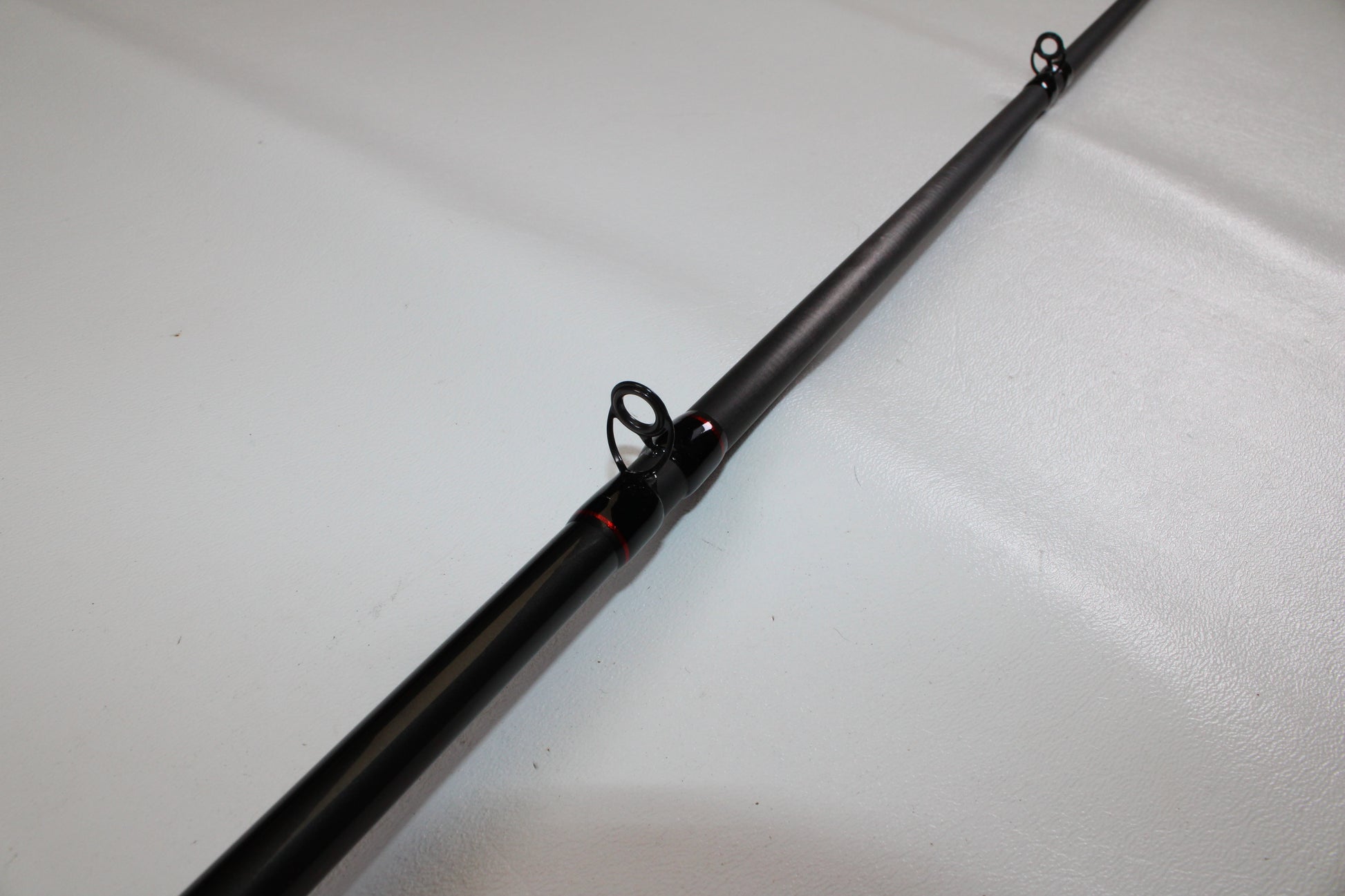 Close-up of a Shimano Intenza NTZC78XH 7'8" XH Used Casting Rod in excellent condition, showing two line guides—ideal for evaluating gear or considering a Rod and Reel Trade-In.