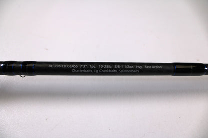 A close-up of the Dobyns Champion XP DC736CBGLASS 7'3" Heavy Used Casting Rod shows specs in white text on a black rod. Trade in your used gear through our Rod and Reel Trade-In Program and earn store credit for your next Dobyns purchase!.