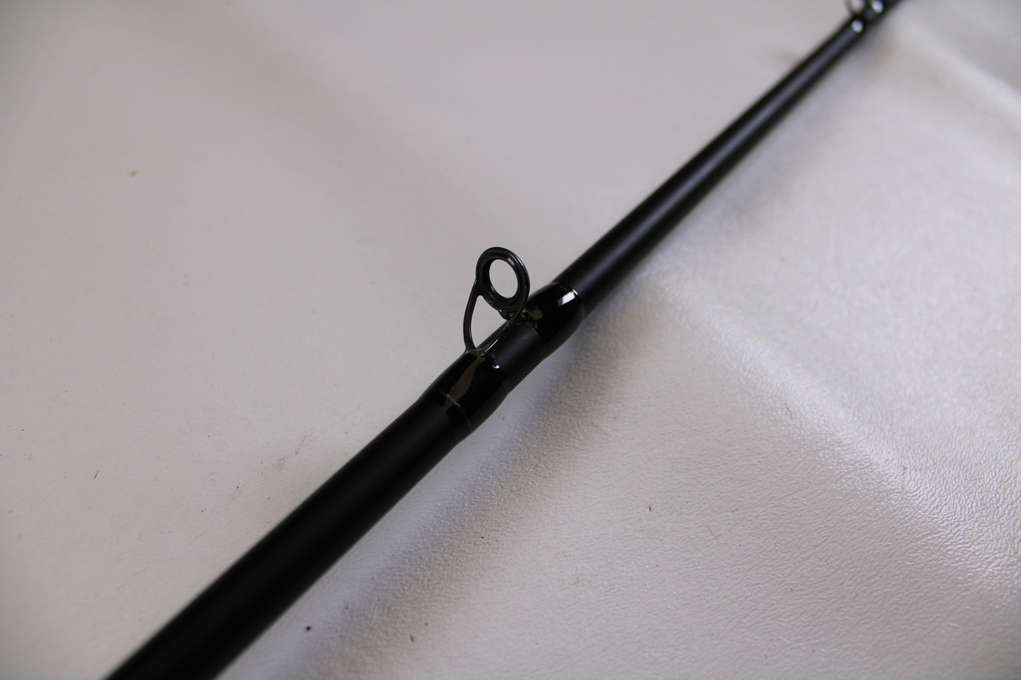 Close-up of a Dobyns Champion XP DC736CBGLASS 7'3" Heavy Used Casting Rod in very good condition, featuring a circular line guide—ideal for upgrading or trading used gear with our Rod and Reel Trade-In Program.
