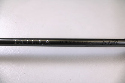 A close-up of the Daiwa Tatula Elite TTEL741MHRB-G 7'4" Medium Heavy Used Casting Rod in very good condition, featuring "TATULA ELITE 7'4" CRANK/BLADED JIG" text and a signature on a black rod—ideal for our Rod and Reel Trade-In Program.