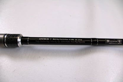 A close-up of the Enigma Ippon EIPN7MB-MH 7'0" Medium Heavy Used Casting Rod in excellent condition, featuring silver accents and detailed specs—trade in your old gear for store credit through the Nation's Best Rod and Reel Trade-In Program.