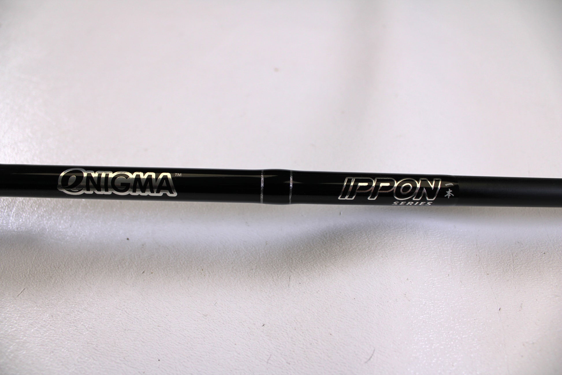 A close-up of the Enigma Ippon EIPN7MB-MH 7'0" Medium Heavy Used Casting Rod in excellent condition—ideal for anglers trading in gear for store credit through the Nation's Best Rod and Reel Trade-In Program.