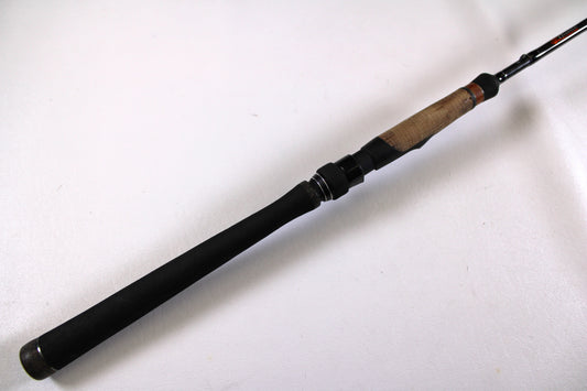 A close-up of the Phenix Ultra MBX-S PHX-UMBXCL-S700M 7'0" Medium Drop Shot Used Spinning Rod in excellent condition, with a black grip and wooden section—ideal for store credit in our top rod and reel trade-in program.
