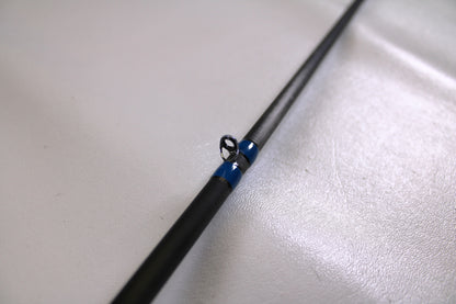 A close-up of the Alpha Angler Slasher 6'10" Medium Used Casting Rod in excellent condition, highlighting a blue-wrapped line guide—ideal for those seeking quality used gear or exploring rod and reel trade-in options.