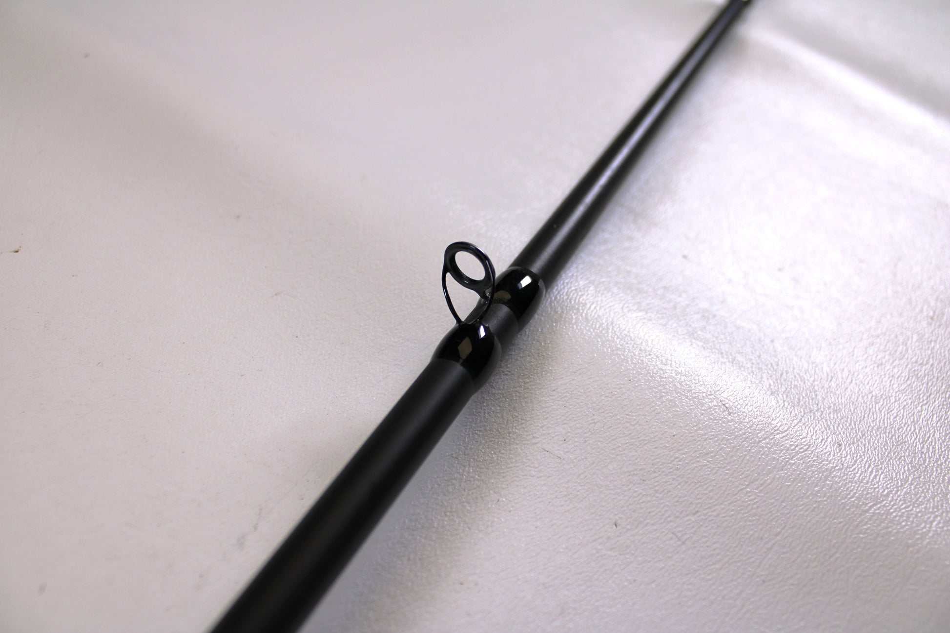 A close-up of the Powell Endurance 755 CB Mod-Fast 7'5" Medium Heavy Used Casting Rod in very good condition, showcasing a line guide—ideal for those trading in used Powell gear for store credit with our Rod and Reel Trade-In Program.