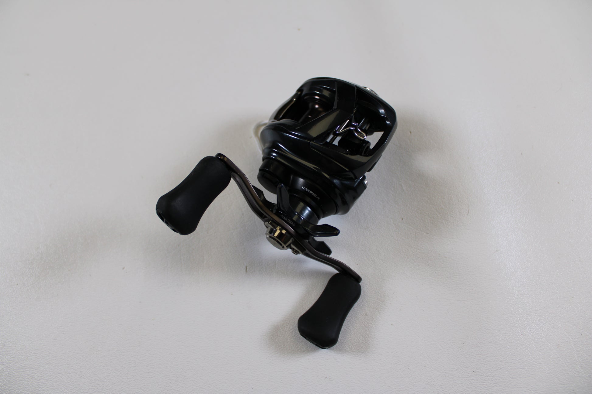 A Daiwa Tatula SV 70 TTUSV70XH Used Casting Reel in excellent condition is displayed on a white surface—ideal for our Rod and Reel Trade-In Program if you want to upgrade your gear and earn store credit.
