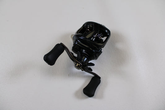 A Daiwa Tatula SV 70 TTUSV70XH Used Casting Reel in excellent condition is displayed on a white surface—ideal for our Rod and Reel Trade-In Program if you want to upgrade your gear and earn store credit.