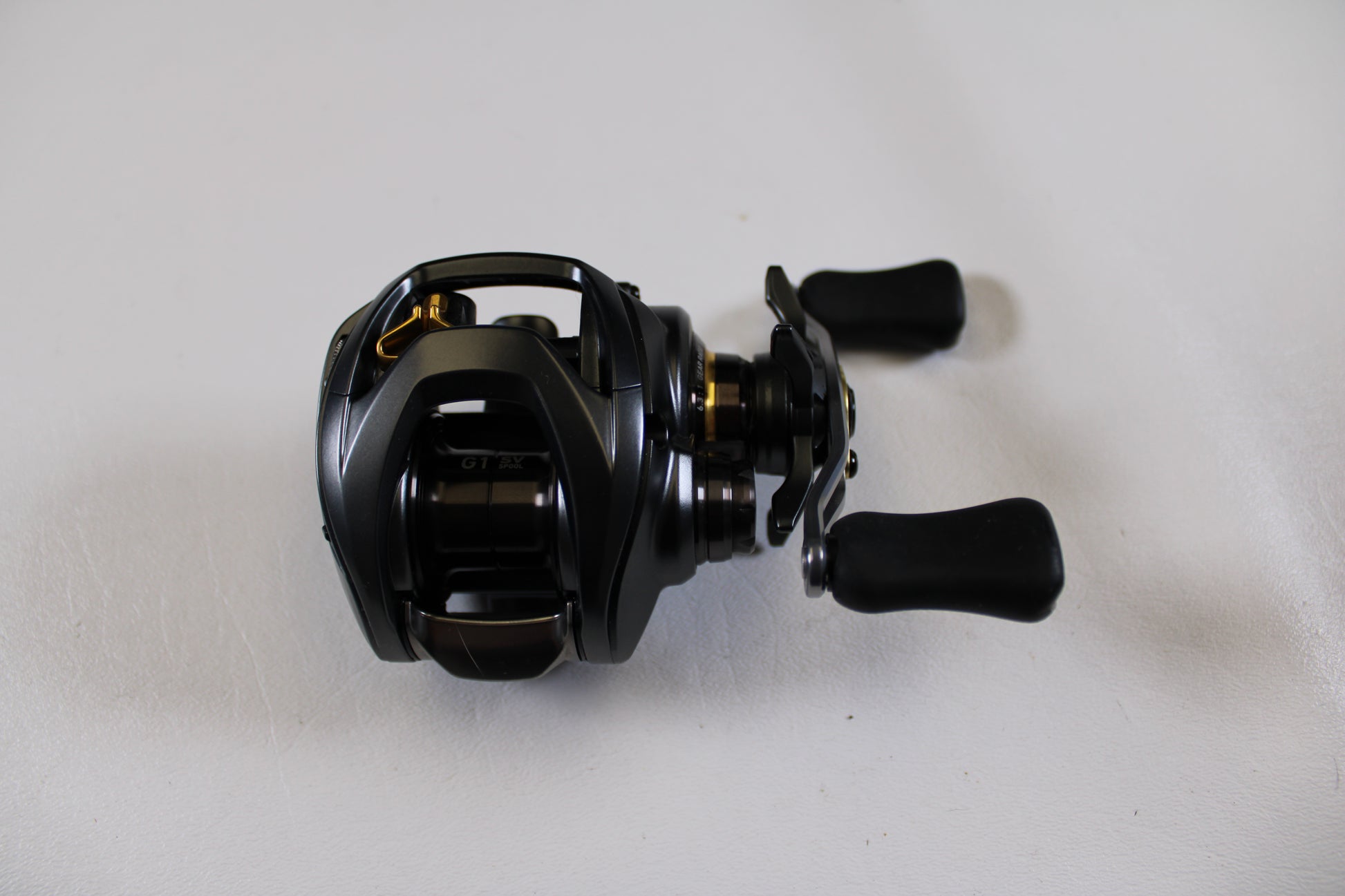 A Daiwa Steez SV TW 1016SV-H 6.3:1 RH casting reel in excellent used condition sits on a white surface—ideal for those exploring our Rod and Reel Trade-In Program or quality Used Gear Condition options.