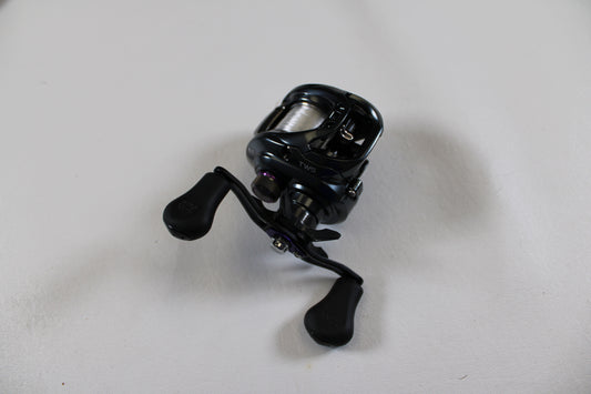 A Daiwa Tatula SV TWS TASV103XS used casting reel in excellent condition sits on a white surface, ready for the Nation's Best Rod and Reel Trade-In Program—ideal for anglers upgrading gear or earning store credit.